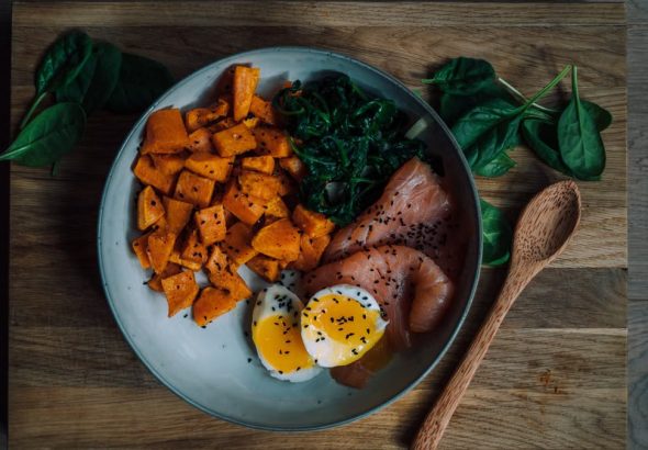 Delicious and nutritious meal featuring salmon, sweet potato, and eggs, perfect for a healthy diet.